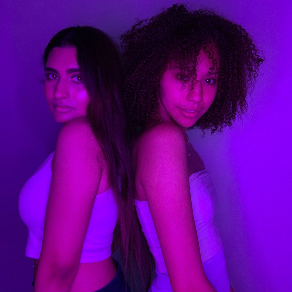 Bright purple filter highlighting two ethnic models' features